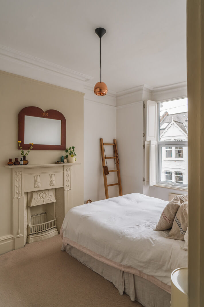 A Charming Light Edwardian House with a Tiny Garden 12 serene bedroom beige fireplace