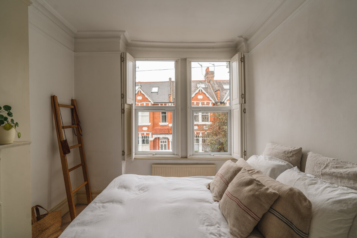 A Charming Light Edwardian House with a Tiny Garden 11 serene bedroom large window with shutters