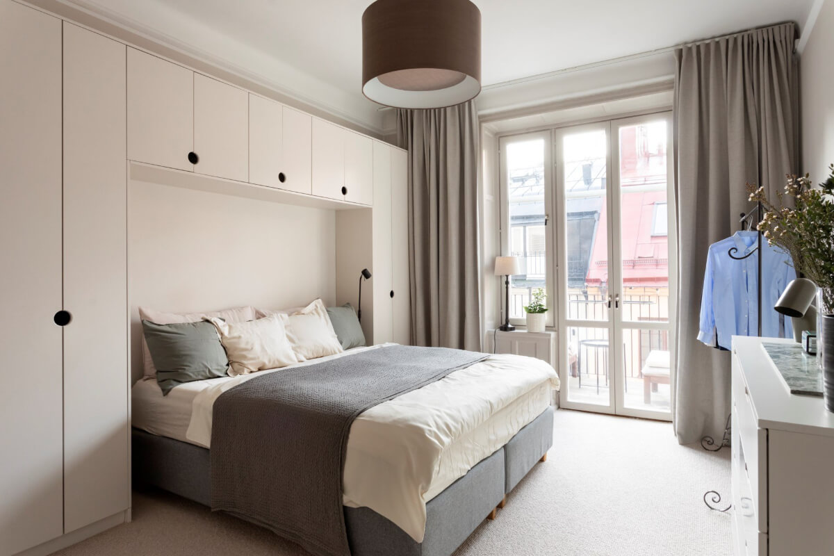 A Stylish Two-Bedroom Apartment in Stockholm 13 serene bedroom with carpet wardrobe around bed