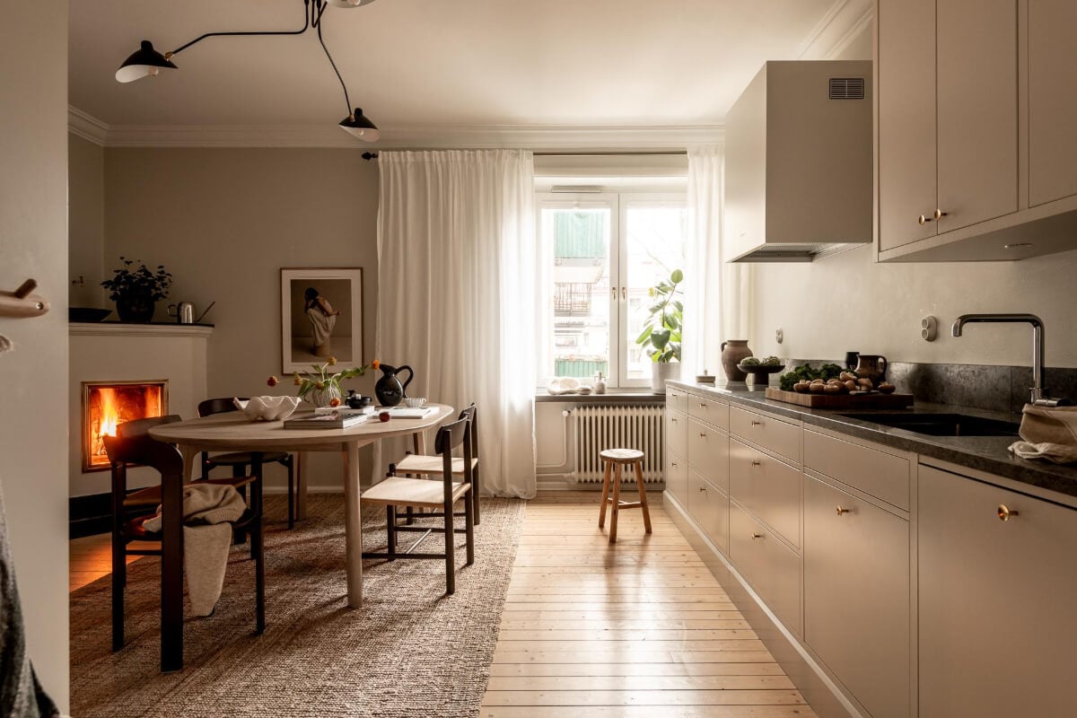 A Beautiful Calm 1920s Apartment in Gothenburg 9 serene kitchen with dining table and fireplace