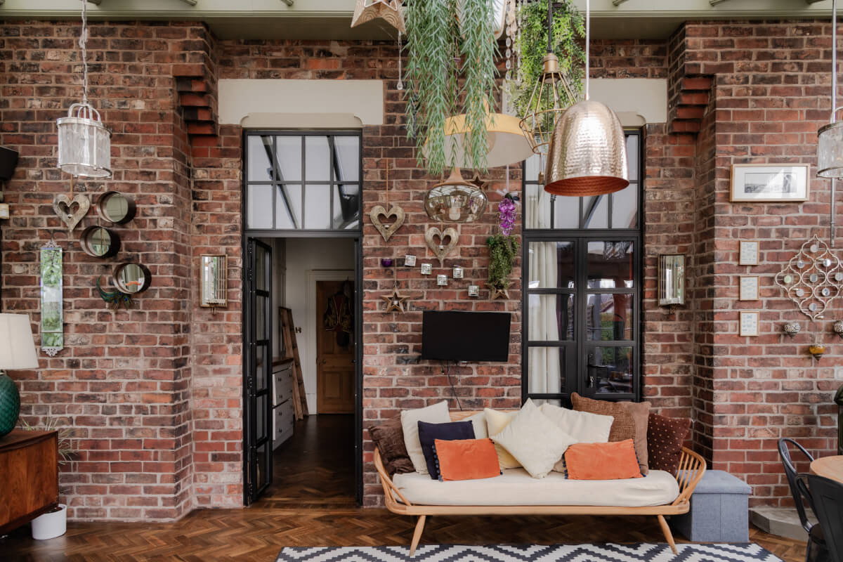 A Grand Victorian Villa in Manchester with Bold Interiors 15 sitting room exposed brick wal