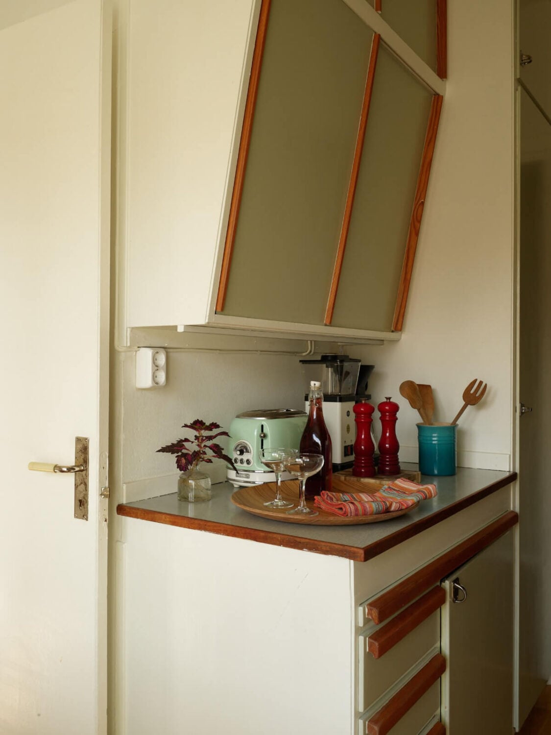 A Charming Midcentury Apartment with Original Features 12 slanted upper cabinets