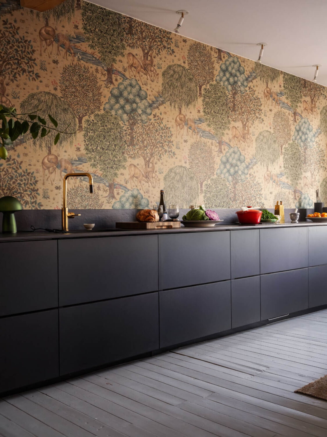 Painted Floorboards in a Unique Family Home in Sweden 6 sleek modern black kitchen cabinets and william morris wallpaper nordroom