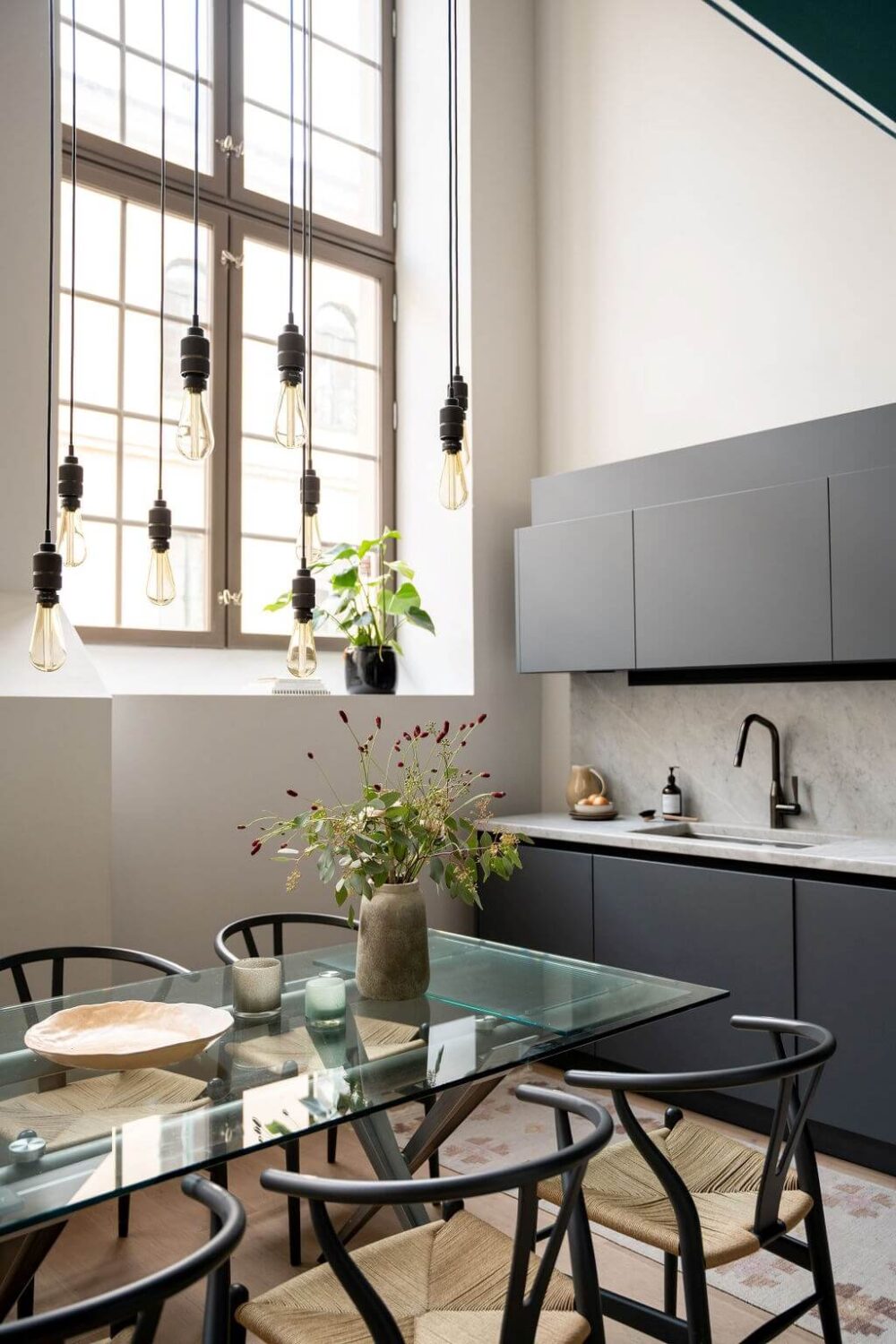 A Loft with High Ceilings and Large Windows in an Exclusive Stockholm Building 7 sleek modern kitchen glass dining table