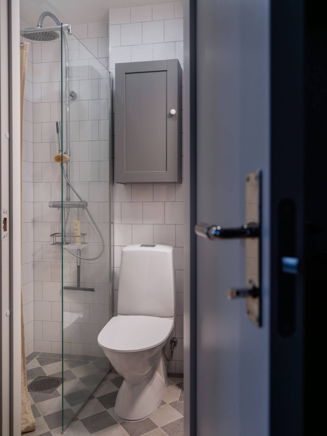 A Studio Apartment with Smart Storage Ideas and Exposed Brick 13 small bathroom checkerboard floor