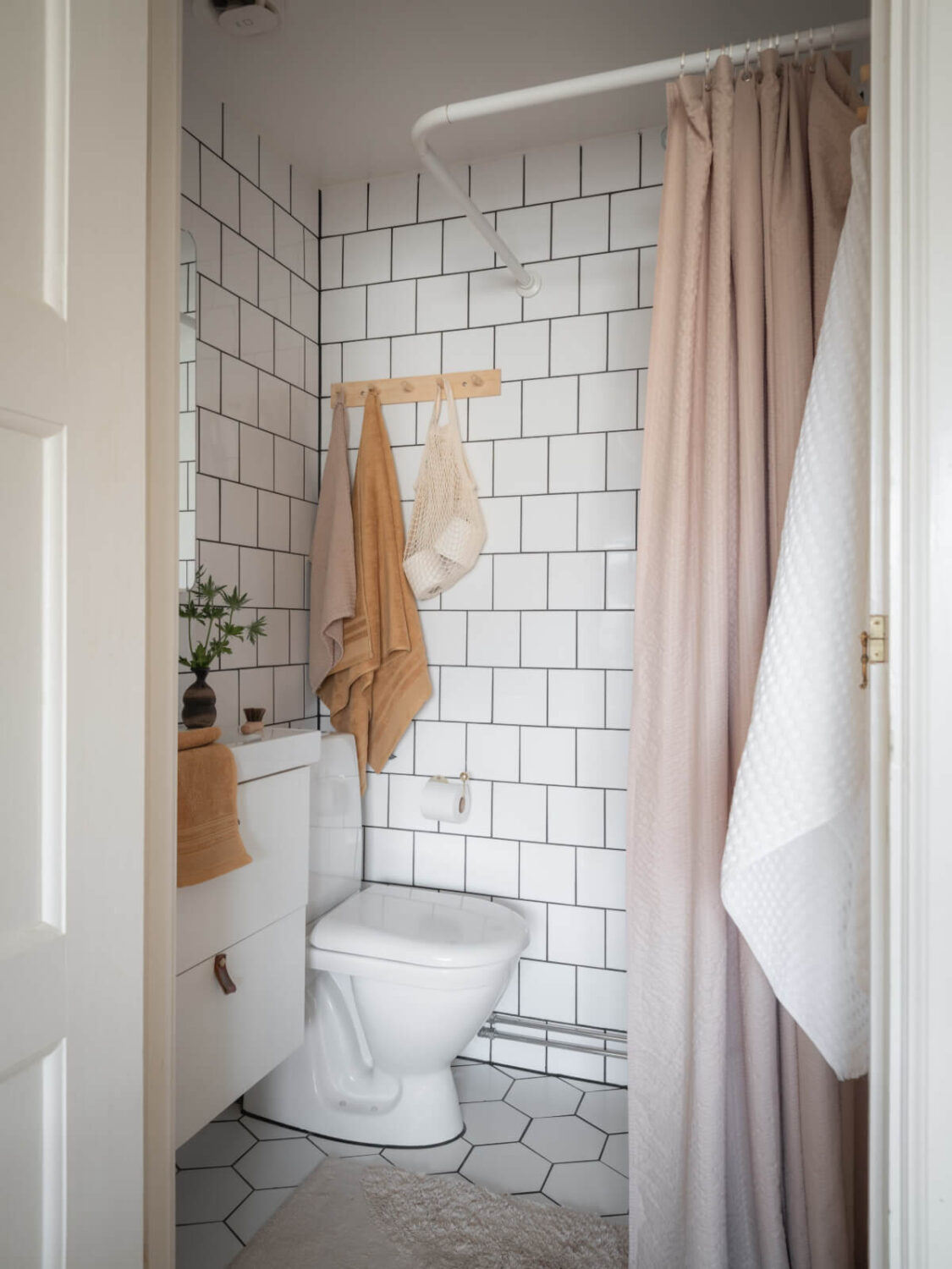 A Renovated Duplex Apartment with Exposed Brick Walls 25 small bathroom white tiles