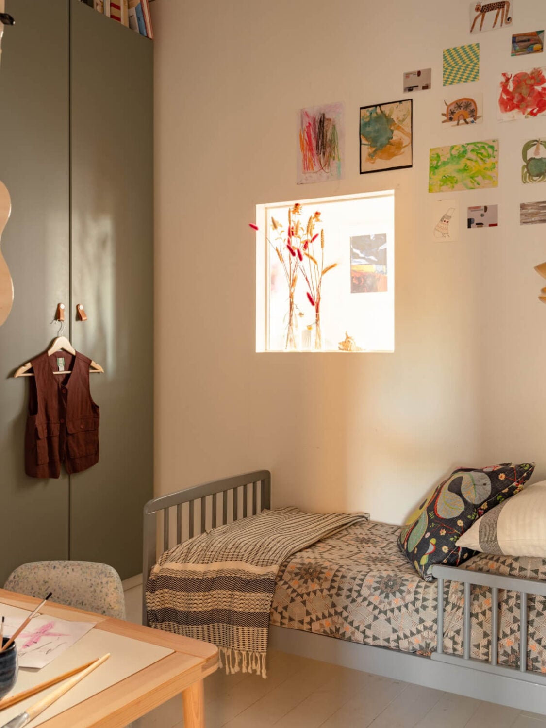 A Charming Midcentury Apartment with a Reading Room 25 small childrens room with sage green wardrobe
