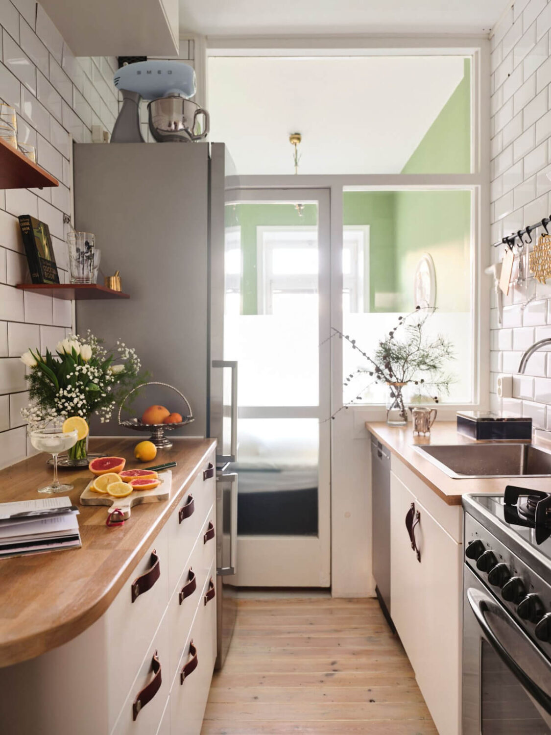 A Small Stockholm Apartment with a Tiny Green Bedroom 15 small galley kitchen white cabinets wooden countertop