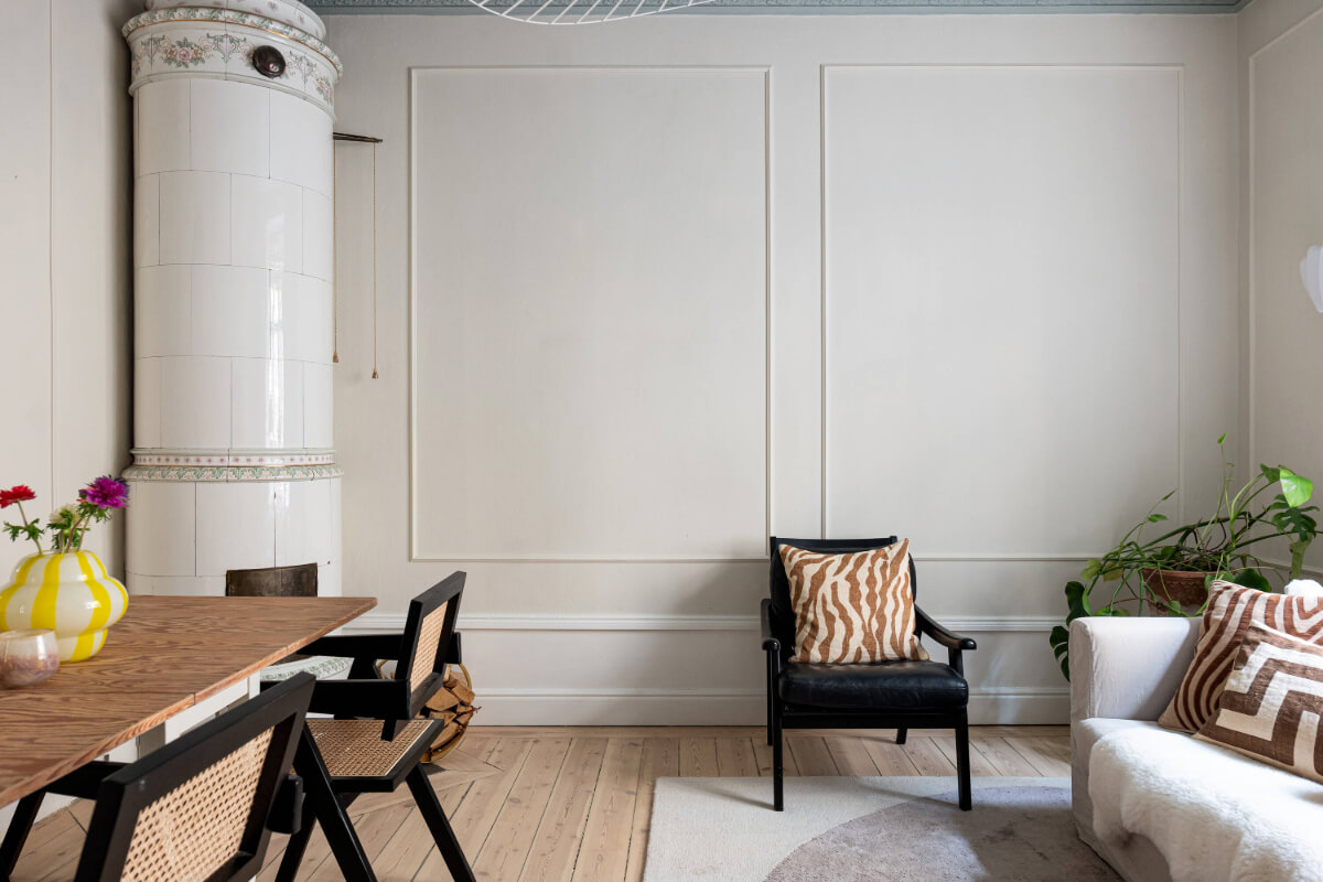 An Elegant Stockholm Apartment with a Pink and Black Kitchen 4 small living room wooden floor fireplace