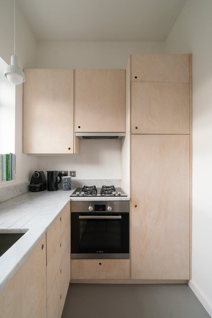 A Light One-Bedroom Apartment in a Victorian Terrace House 9 small plywood kitchen marble countertop