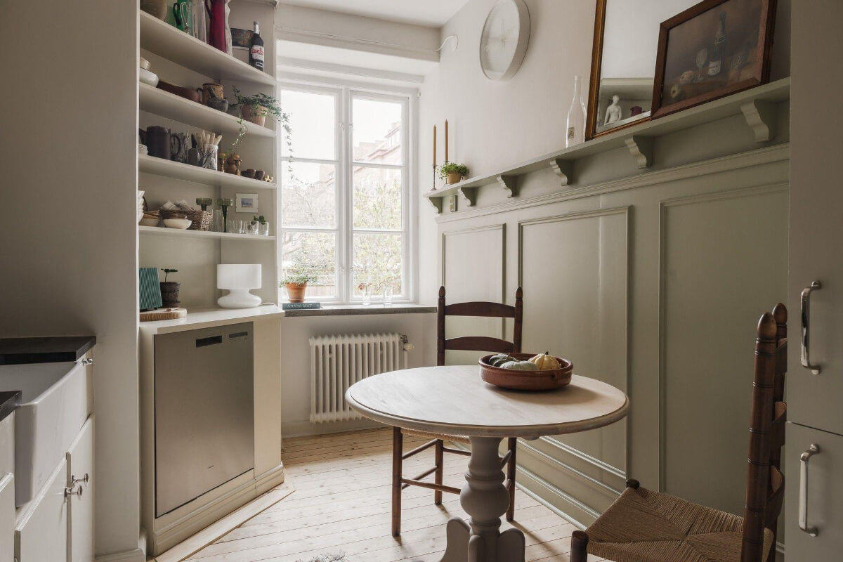 Natural Tones and Original Elements in a 1930s Apartment 9 small round wooden table beige midcentury kitchen
