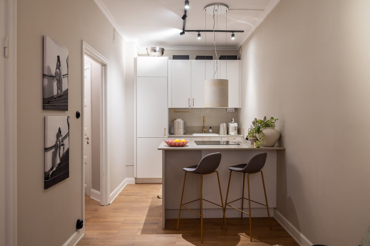 A Tiny and Luxurious Apartment in Stockholm 8 small white kitchen with island