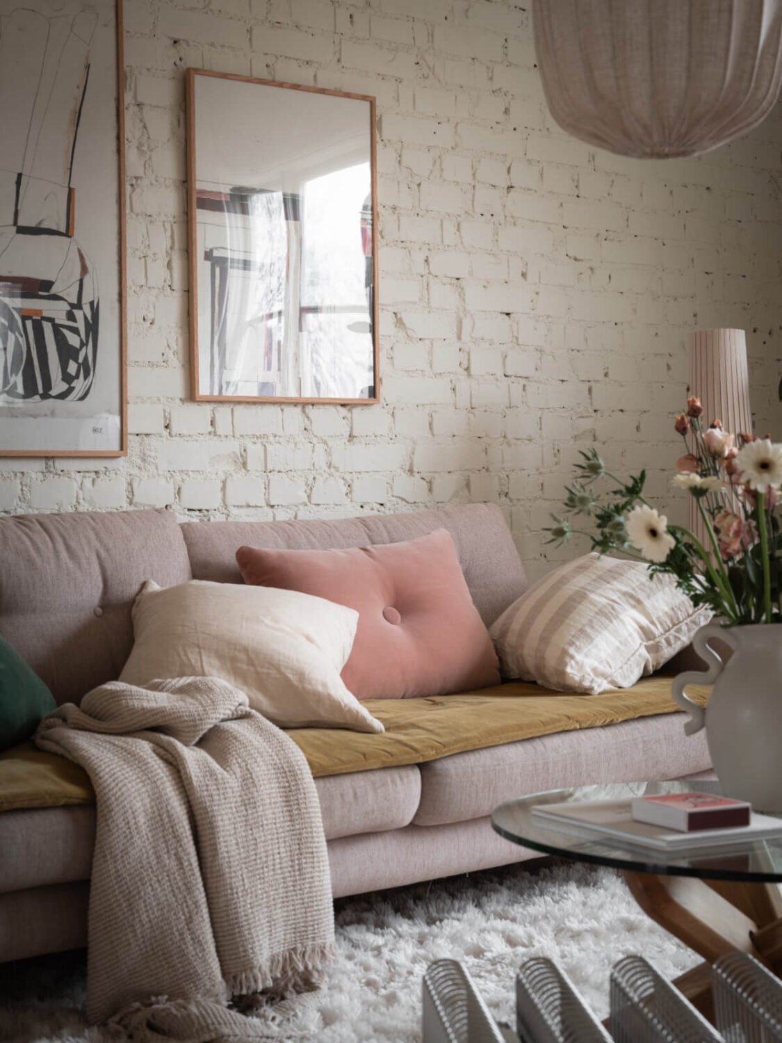 A Renovated Duplex Apartment with Exposed Brick Walls 4 sofa muted color accents white painted brick wall nordroom