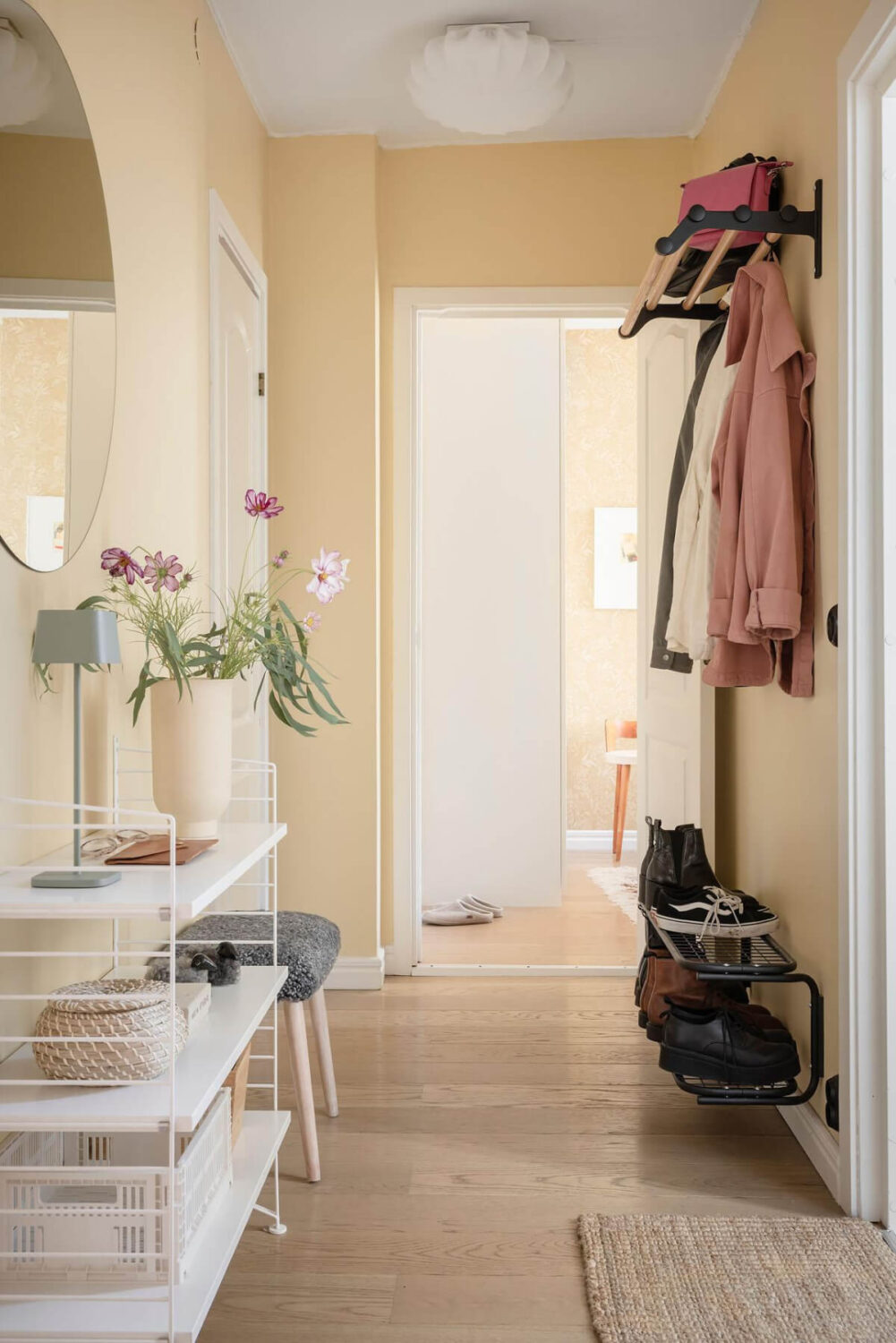 Bright Rooms with Light Color Tones in a Swedish Apartment 28 soft yellow hallway open storage Bright Rooms with Light Color Tones in a Swedish Apartment