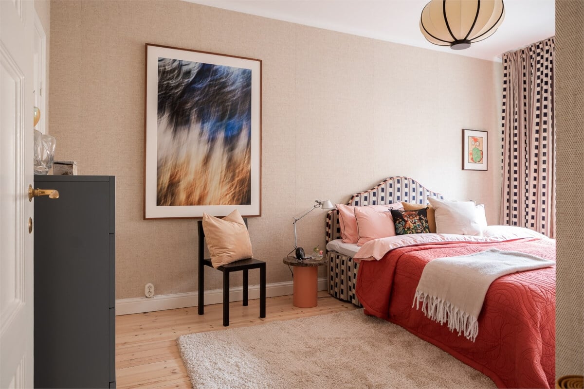A Light-Filled Two Bedroom Apartment in Stockholm 14 spacious bedroom beige-pink wallpaper