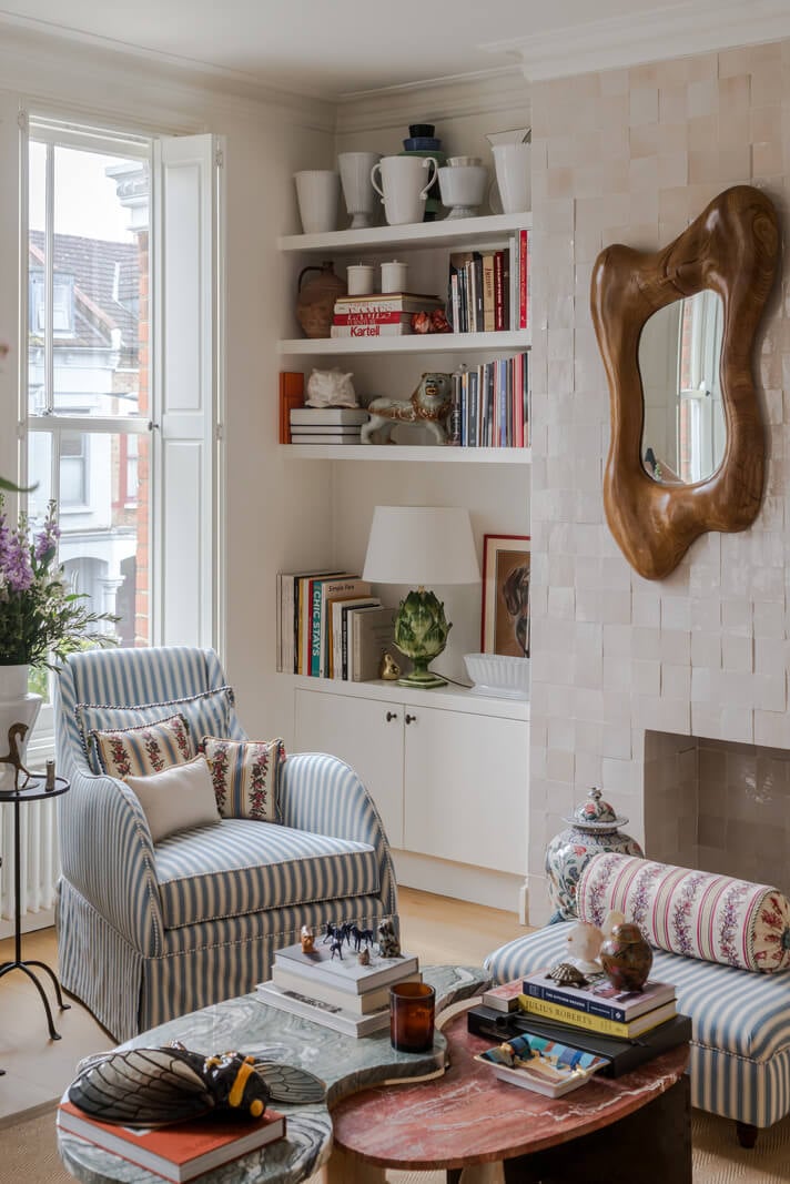 Cozy Contemporary Spaces in a Light-Filled Victorian Apartment 3 striped armchair bookshelves large windows living room