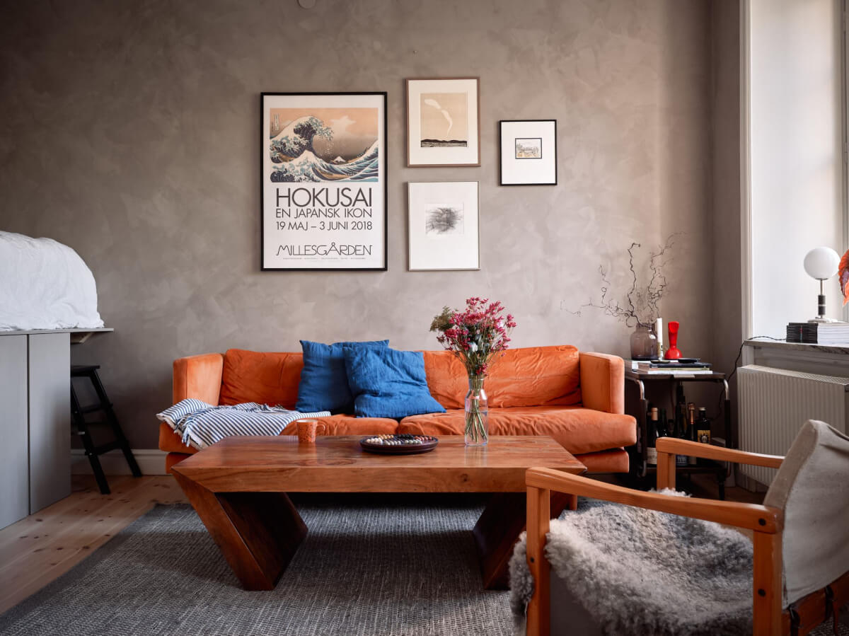 A Studio Apartment with Smart Storage Ideas and Exposed Brick 3 studio apartment gray plaster wall