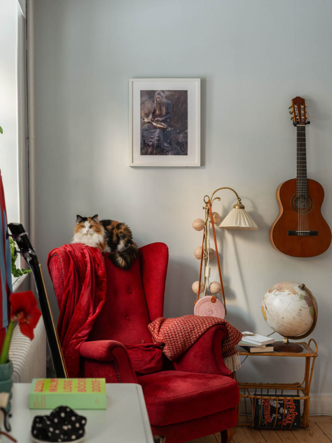 A Charming and Light-Filled Studio Apartment in Stockholm 4 studio apartment red armchair and cat