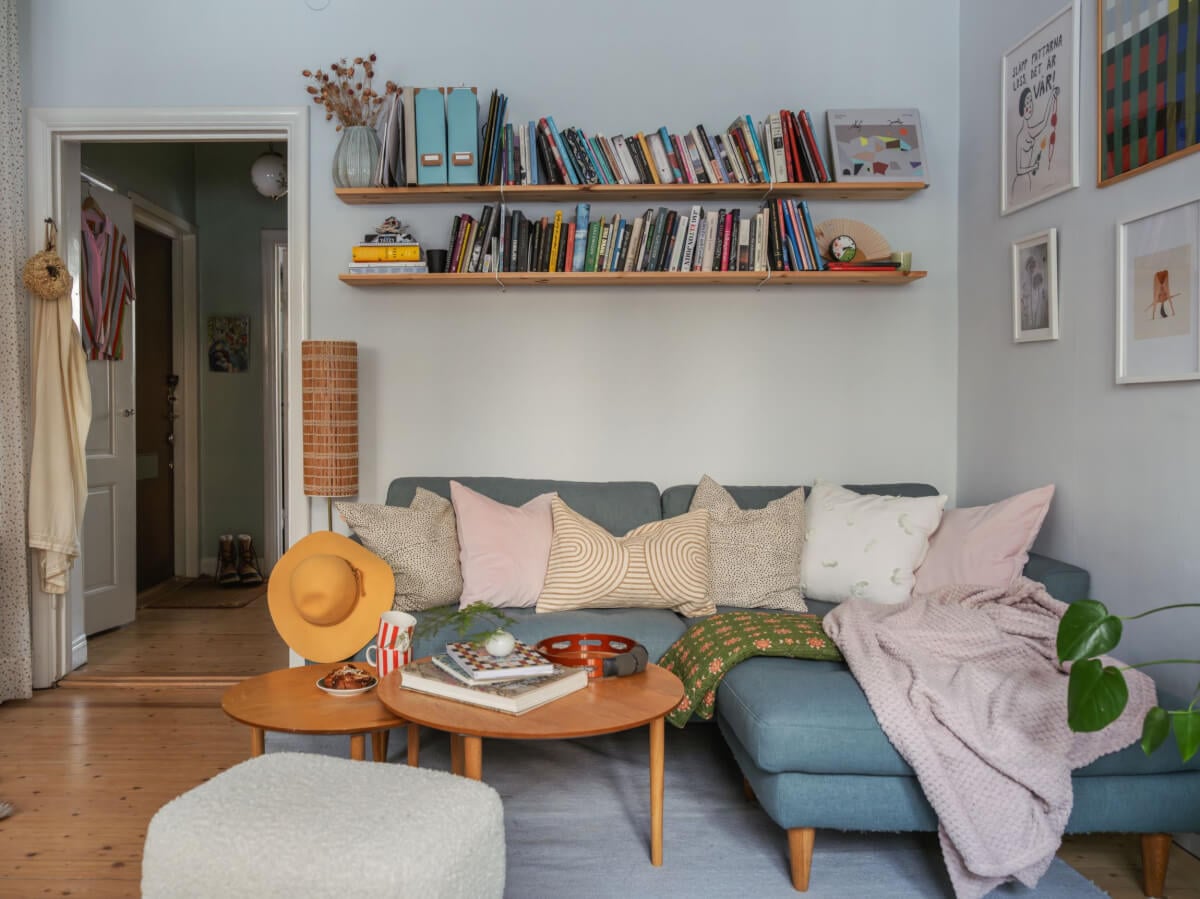 A Charming and Light-Filled Studio Apartment in Stockholm 2 studio apartment sitting area with bookshelves