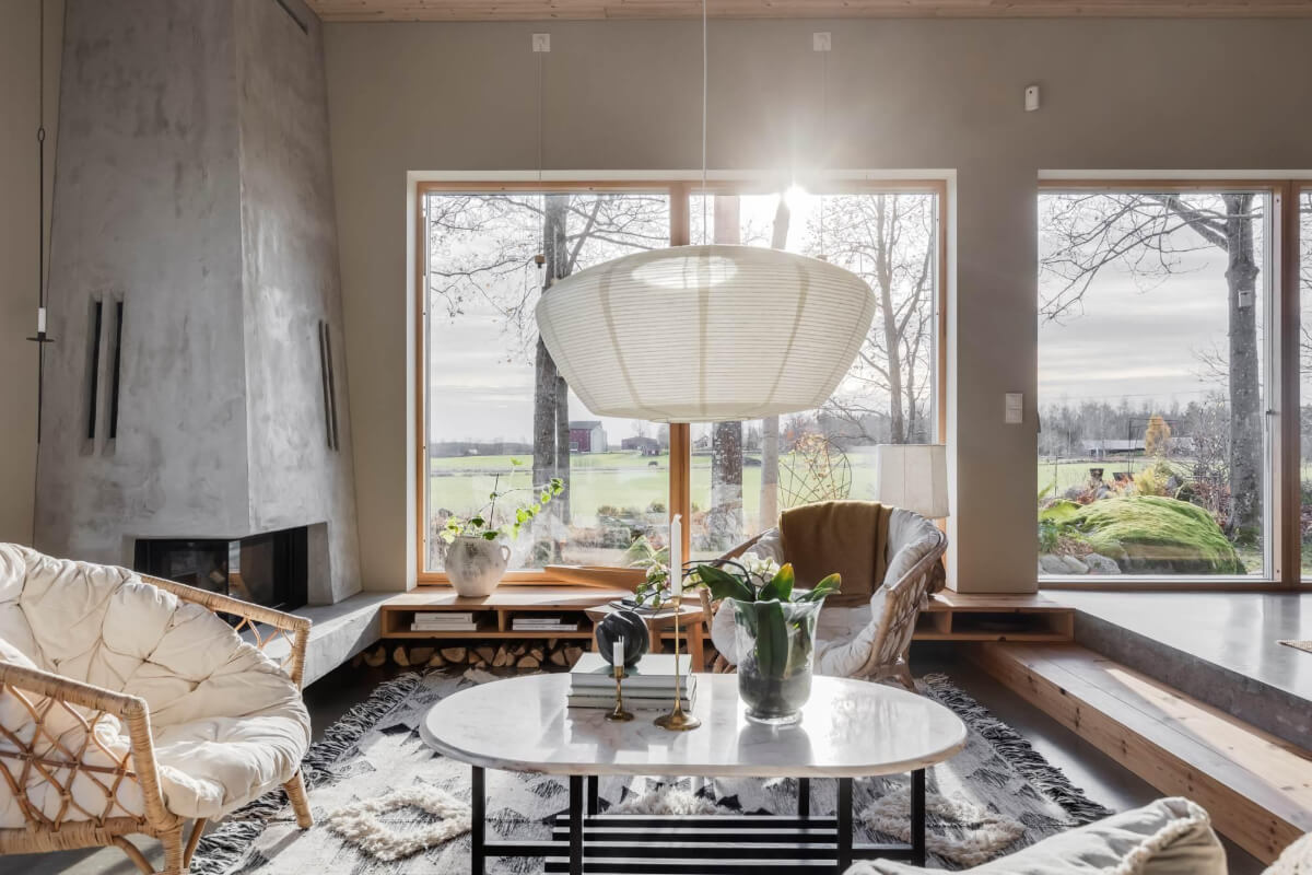 A Swedish Architectural Villa Surrounded by Nature 1 sunken living room with concrete fireplace
