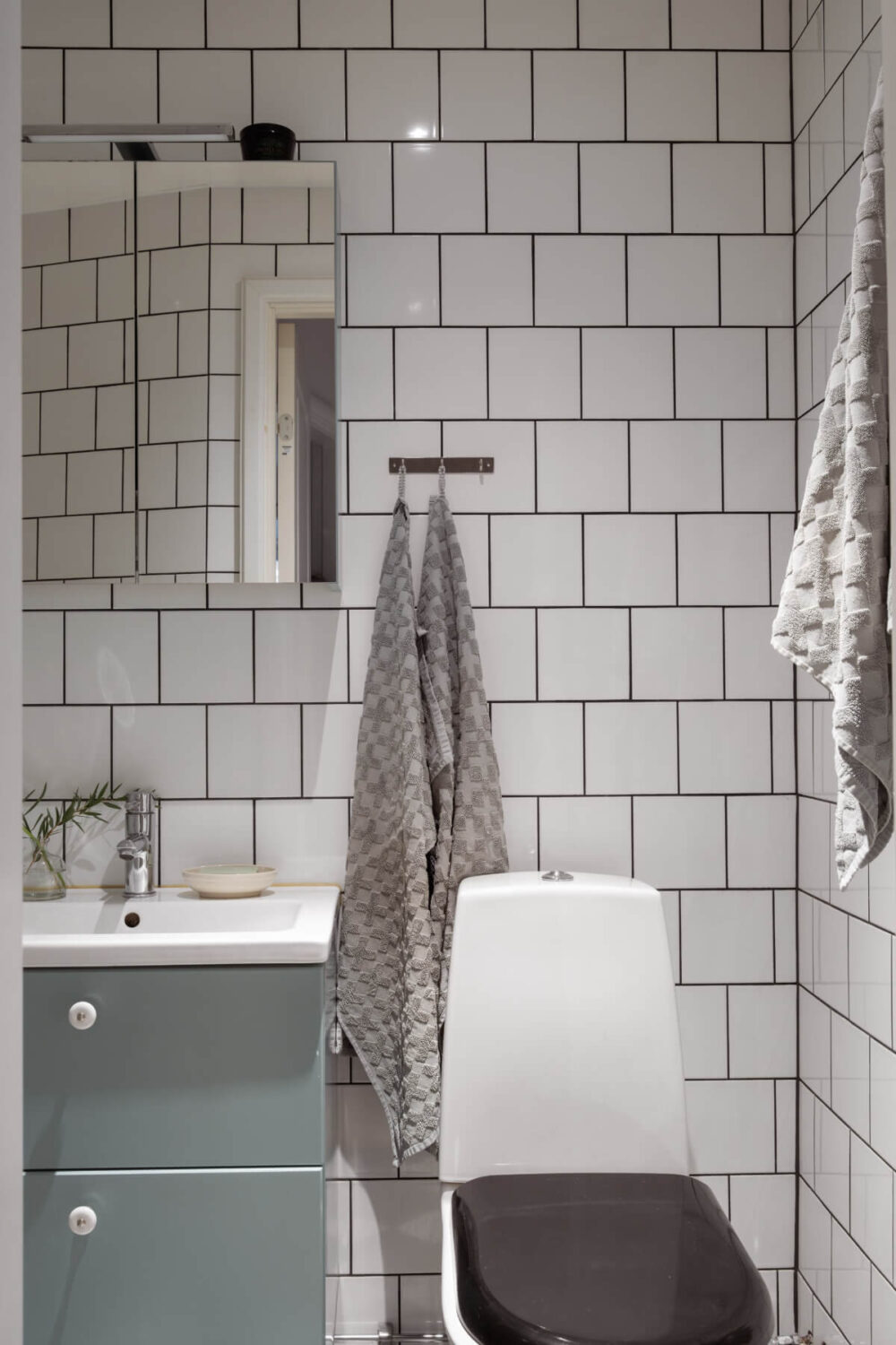 A Swedish Maisonette Apartment with Basement Bedrooms 17 tiny bathroom white tiles
