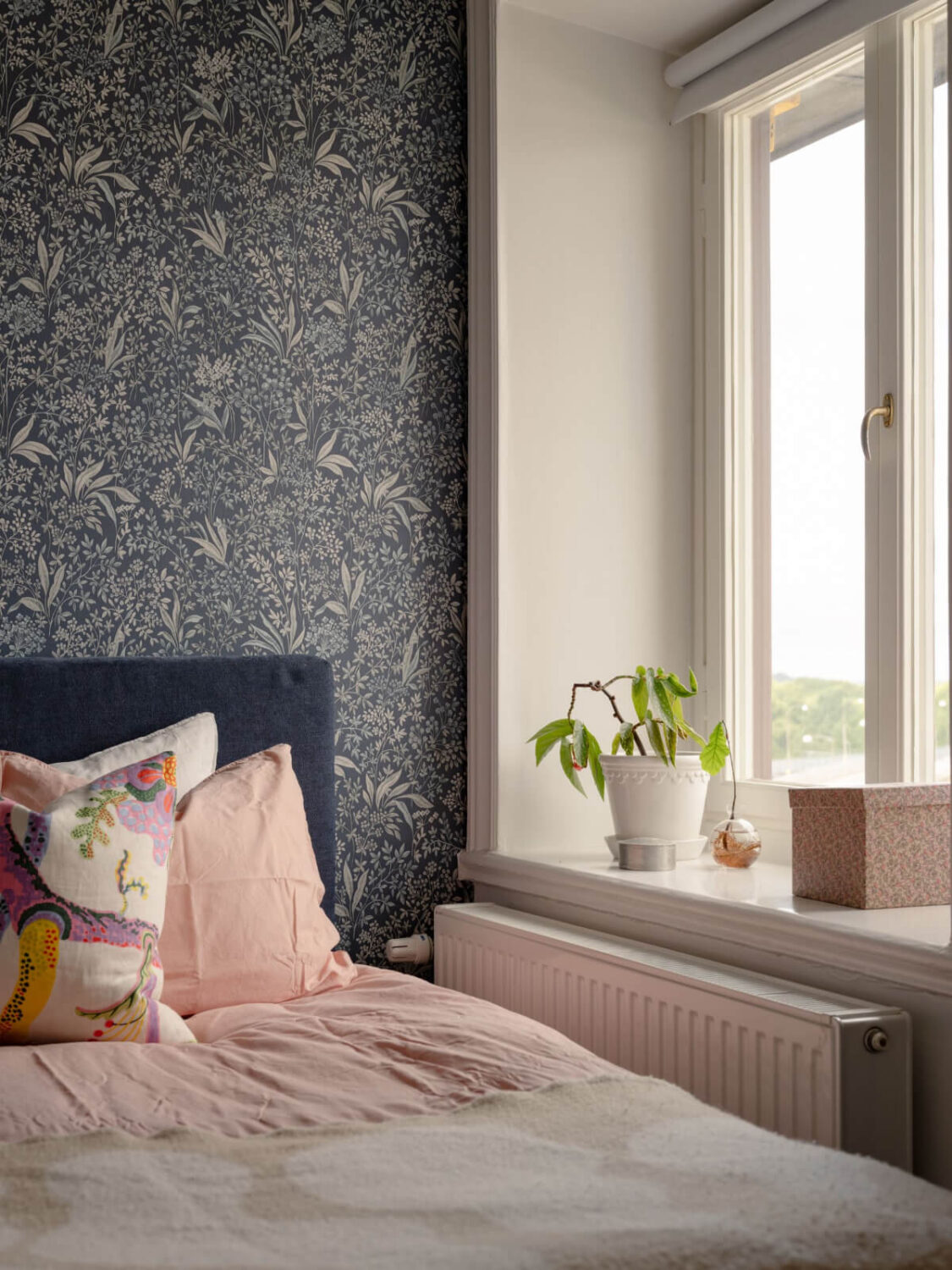 A Small Apartment with High Ceilings and a Large Bay Window 12 tiny bedroom blue floral wallpaper