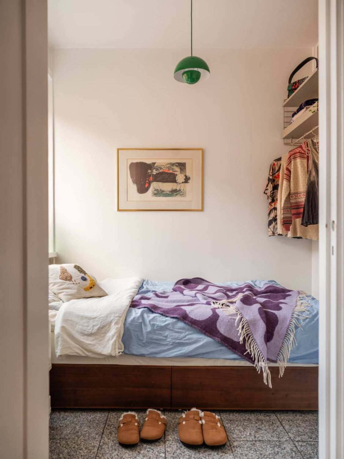 An Airy One-Bedroom Apartment with Art and A Yellow Kitchen 6 tiny bedroom tile floor