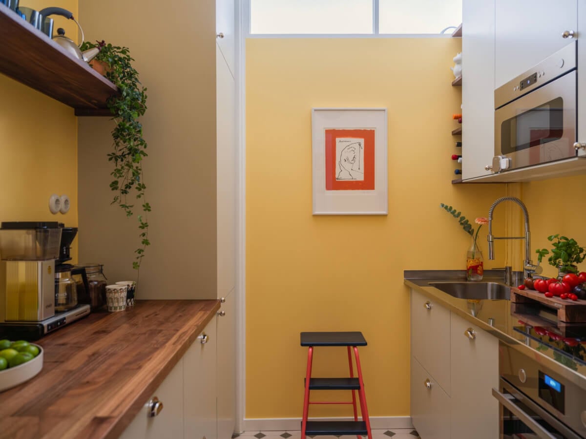 An Airy One-Bedroom Apartment with Art and A Yellow Kitchen 19 tiny kitchen yellow walls