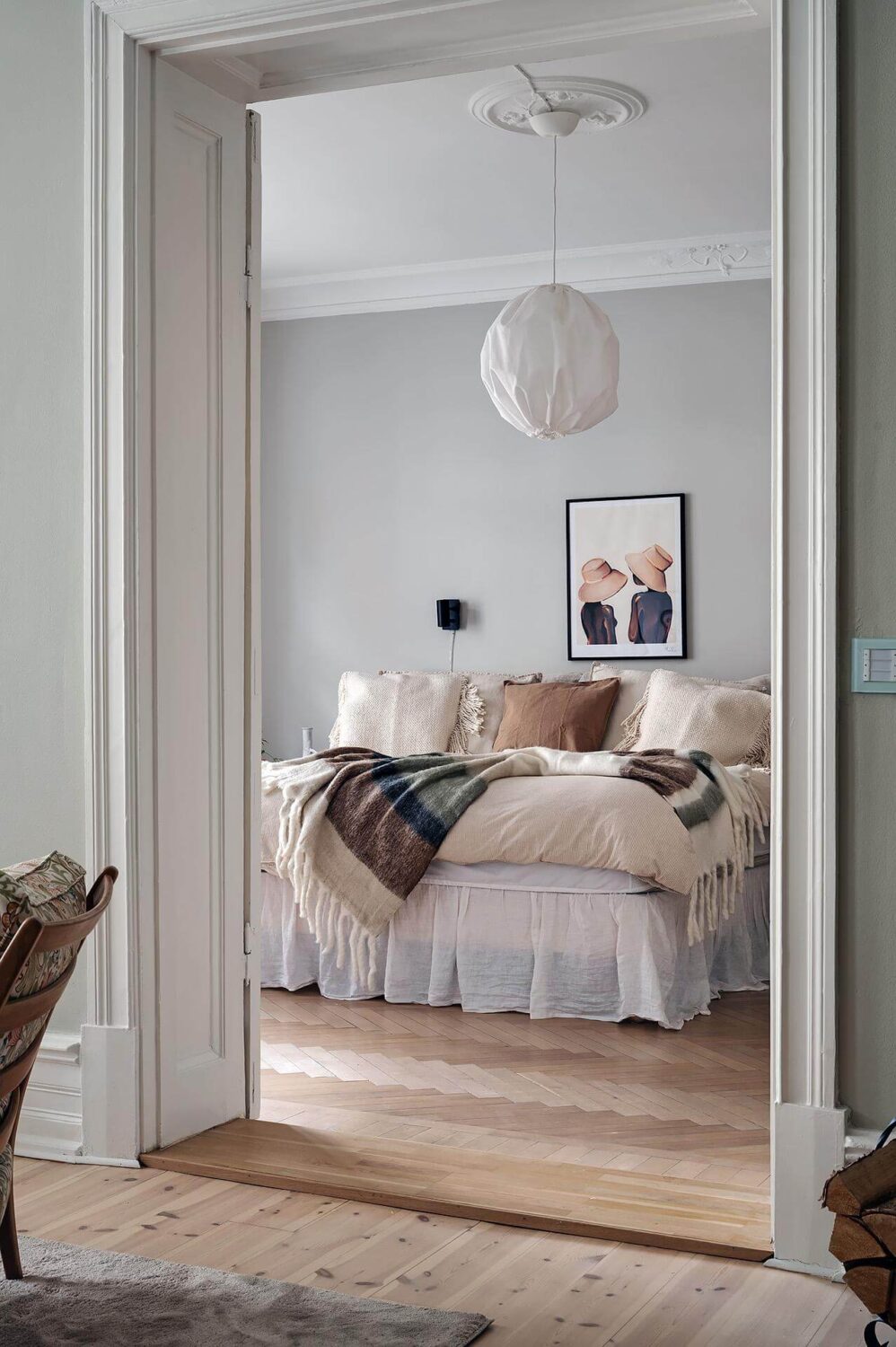 A Swedish Apartment with an Open Living Space and Period Features 20 view into bedroom