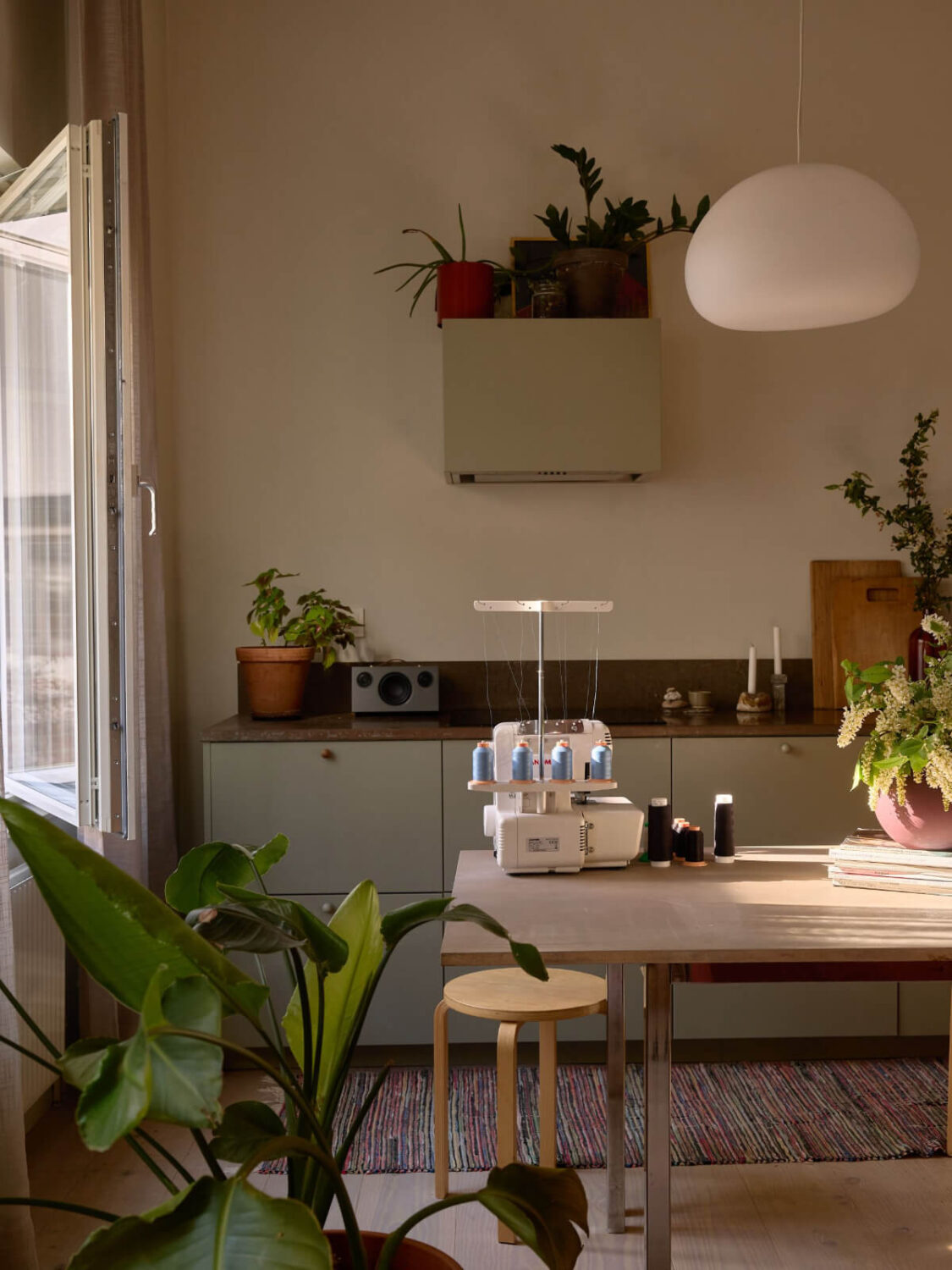 High Ceilings in a Small Swedish Loft Designed for a Family 4 view into green kitchen