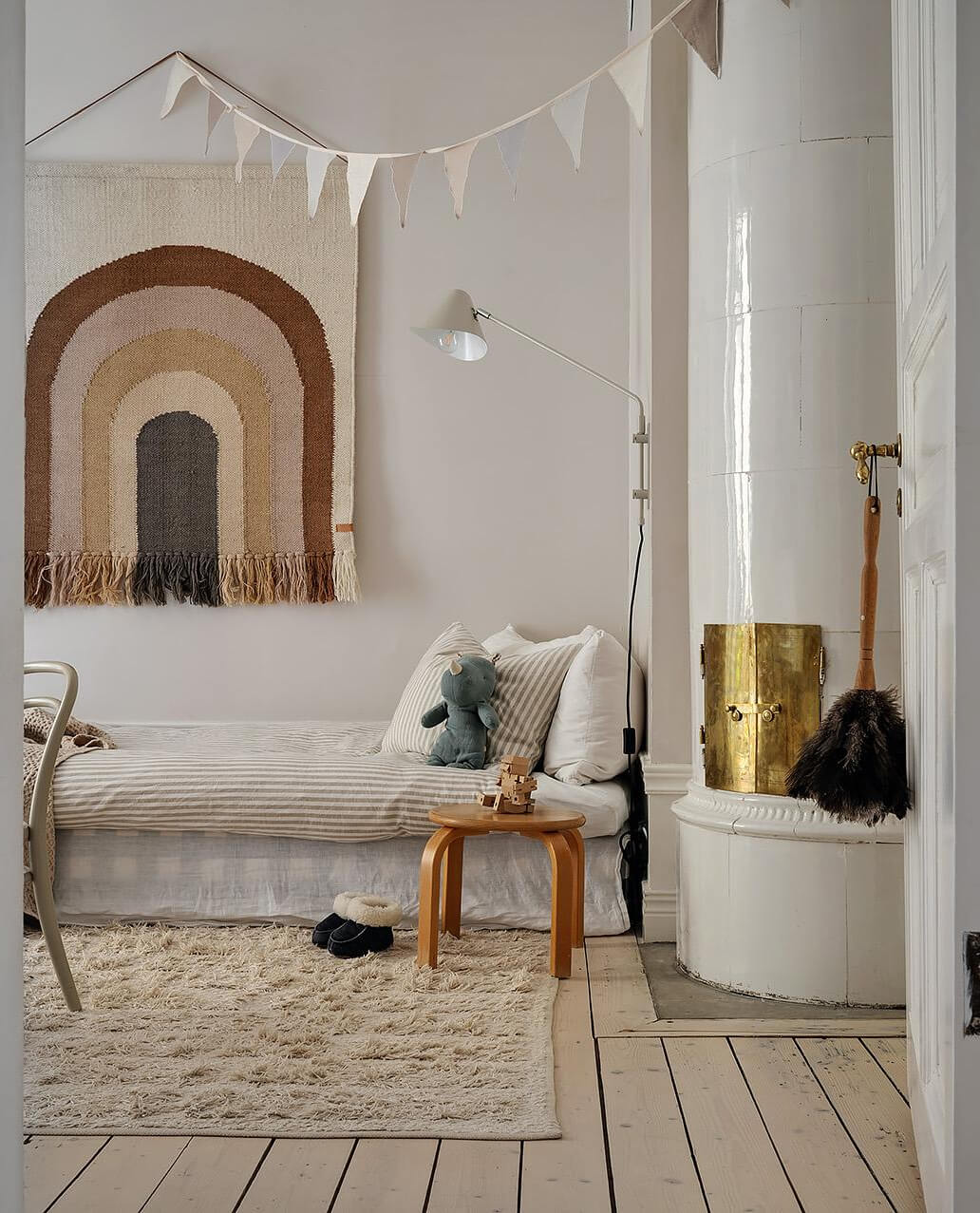 Period Features and Modern Materials in a Swedish Apartment 28 view into kids bedroom with fireplace