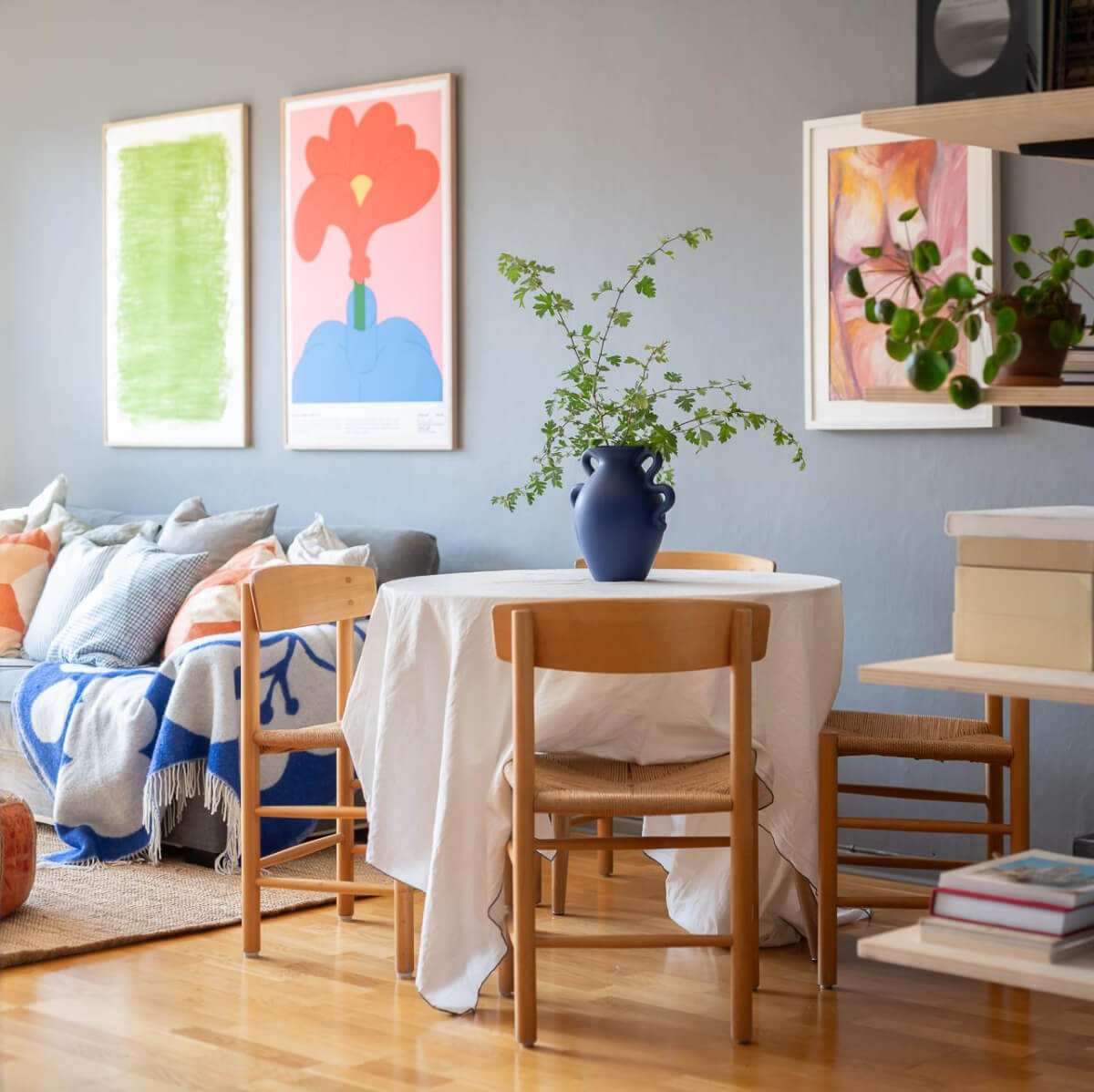 Light Rooms and a Moody Color Palette in a 1930s Apartment 2 view into living room round table