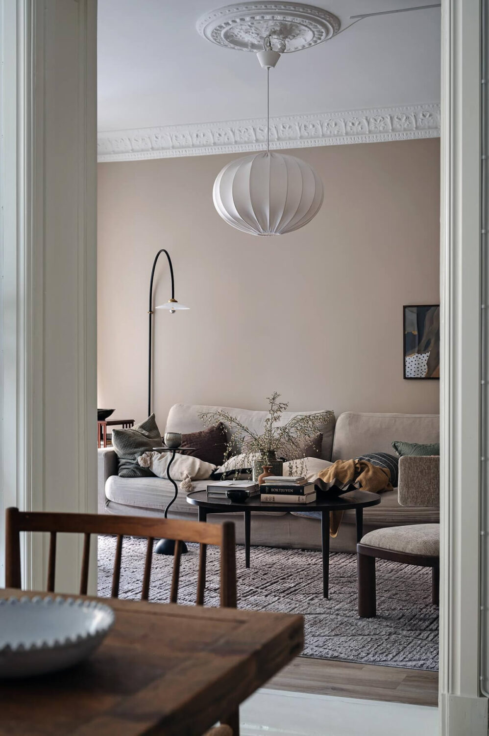 Warm and Inviting Rooms in a Renovated Swedish Apartment 18 view into living room warm brown-beige walls