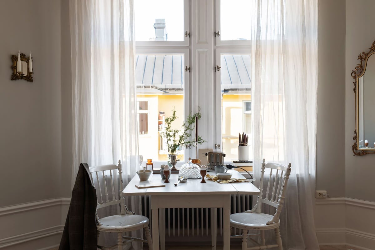 A Small Light Gray Apartment with Period Features 11 vintage table under window