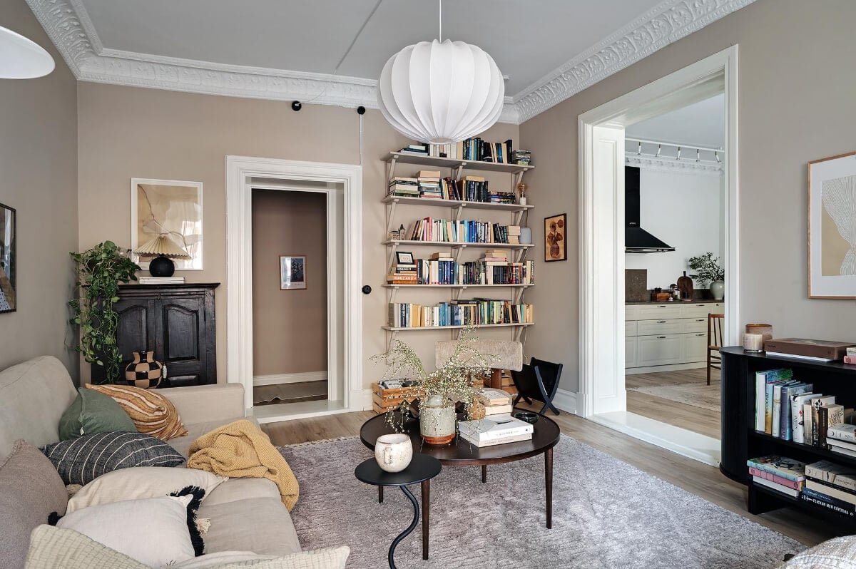 Warm and Inviting Rooms in a Renovated Swedish Apartment 7 warm living room bookshelves