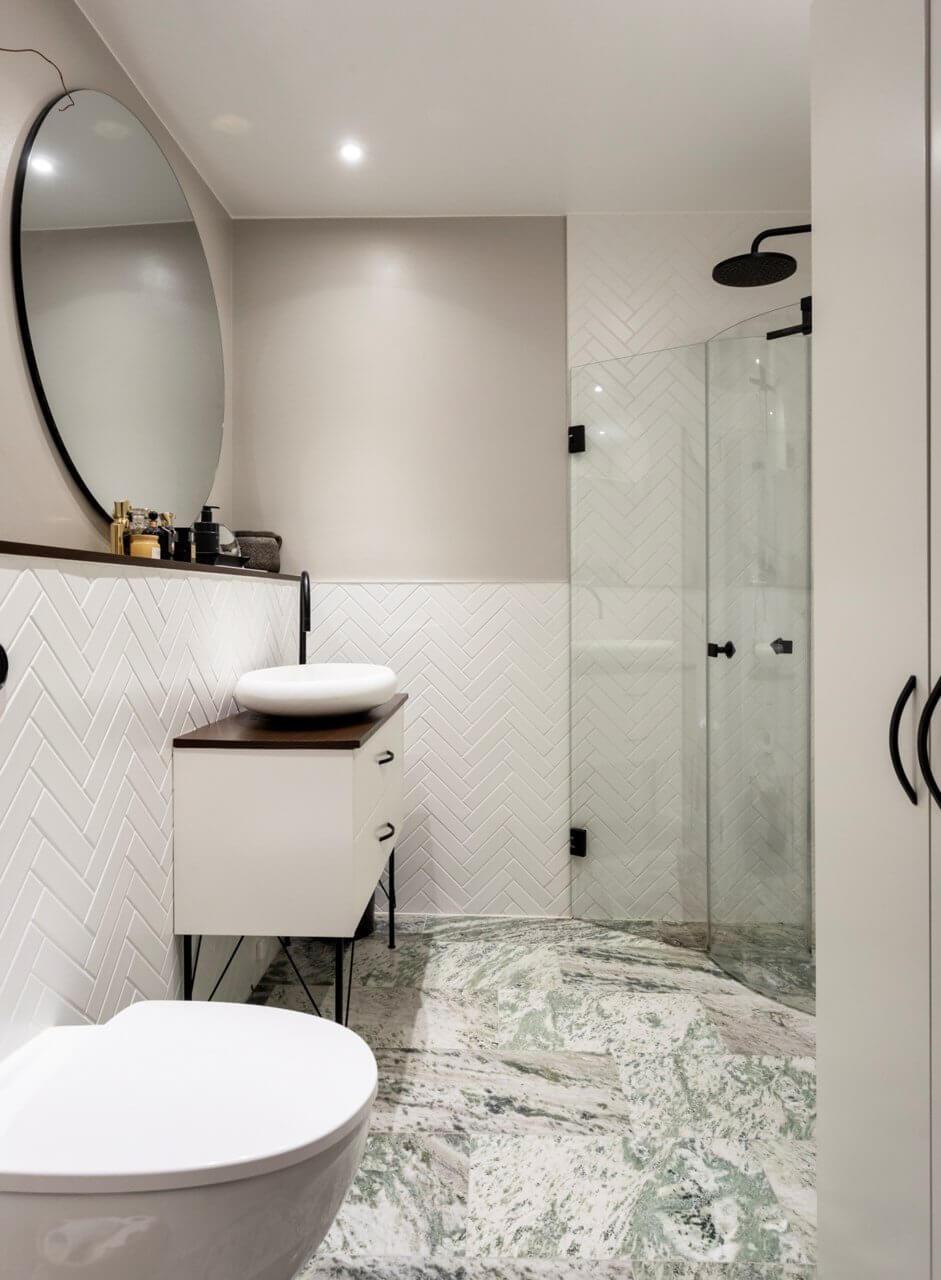 A Stylish Two-Bedroom Apartment in Stockholm 22 white bathroom tiles black fittings