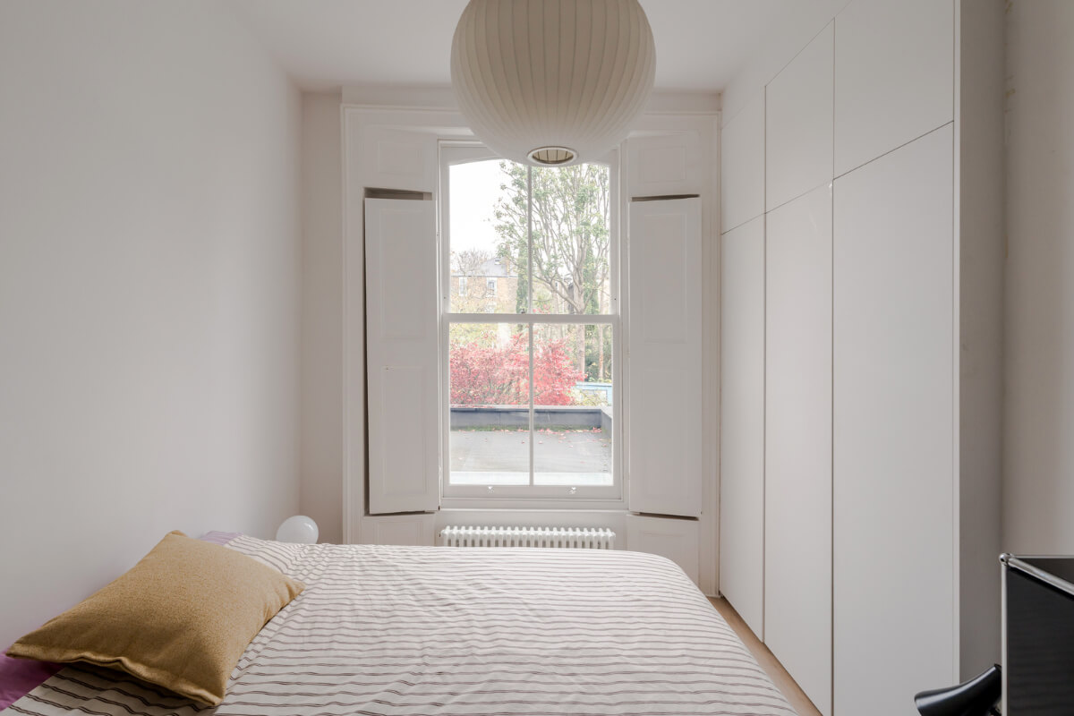 A Modern Apartment in a London Victorian House 16 white bedroom built-in wardrobes window shutters