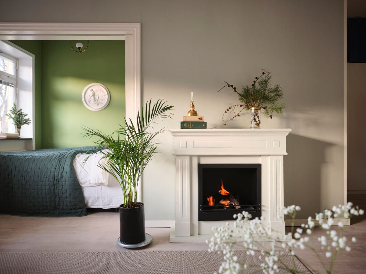 A Small Stockholm Apartment with a Tiny Green Bedroom 11 white fireplace