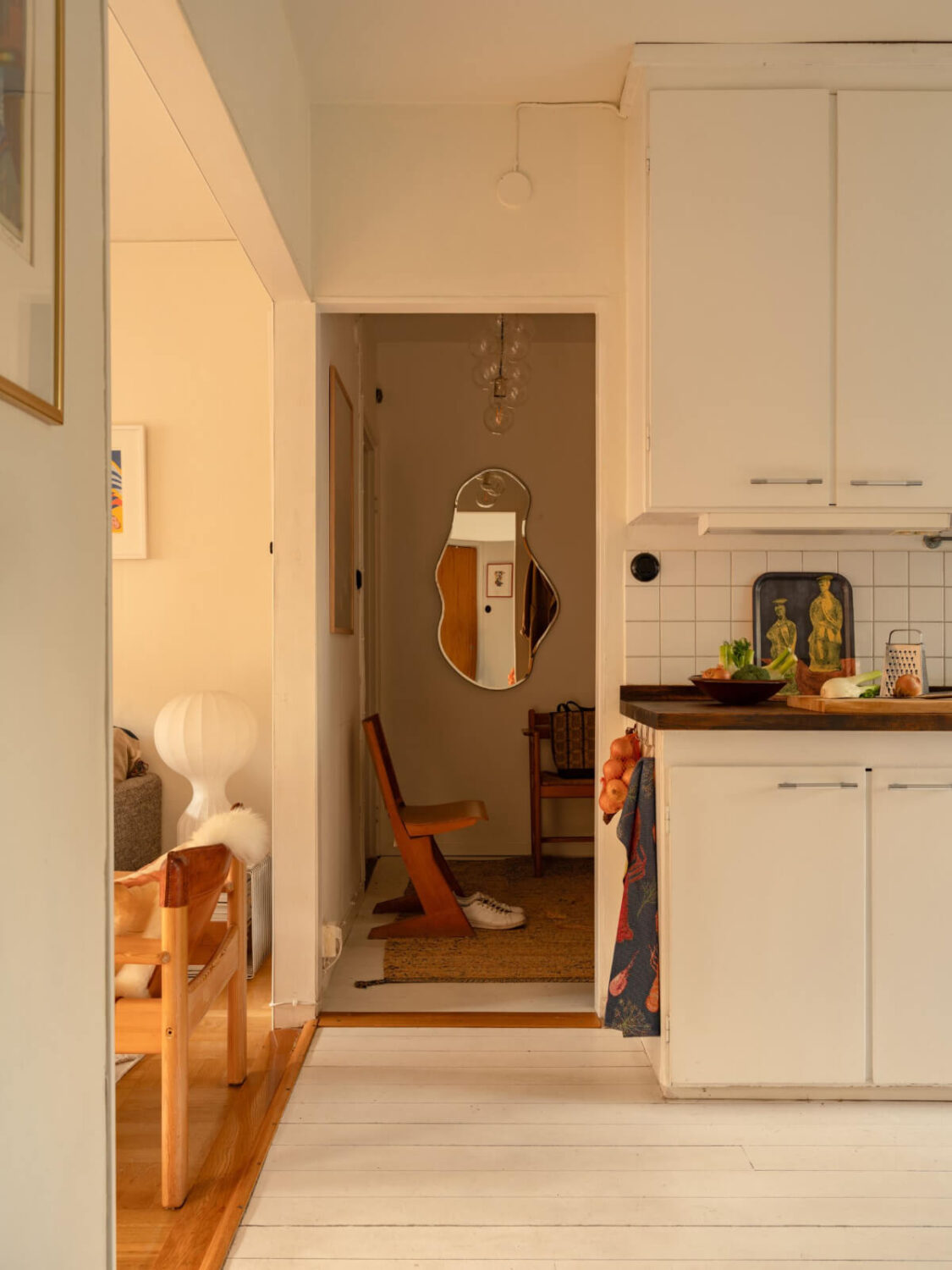 A Charming Midcentury Apartment with a Reading Room 14 white floorboard in kitchen