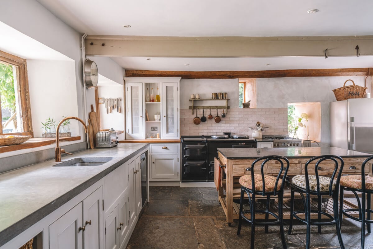 A Beautiful Renovated Country House in England 6 white kitchen copper tap stone floor