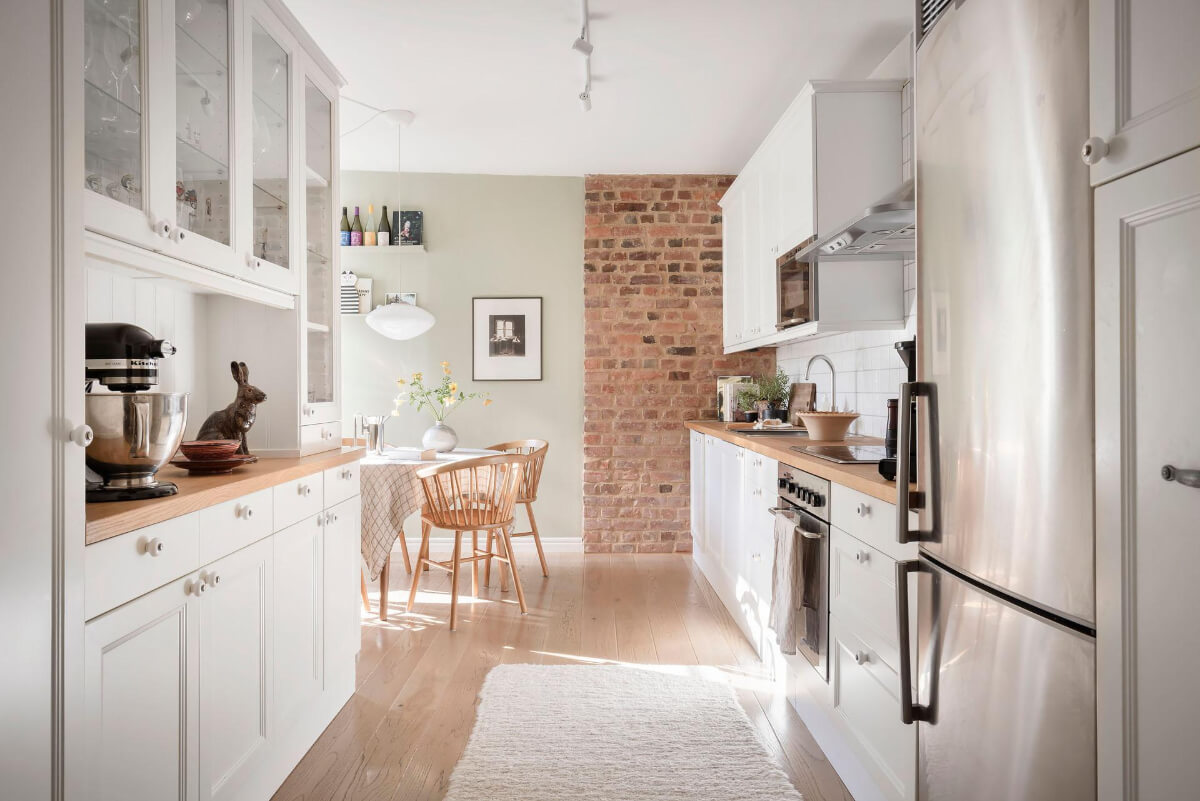 Bright Rooms with Light Color Tones in a Swedish Apartment 10 white kitchen with brick wall