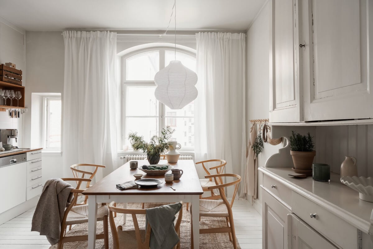 A Stylish Studio Apartment with Period Features and Large Windows 14 white kitchen with large table