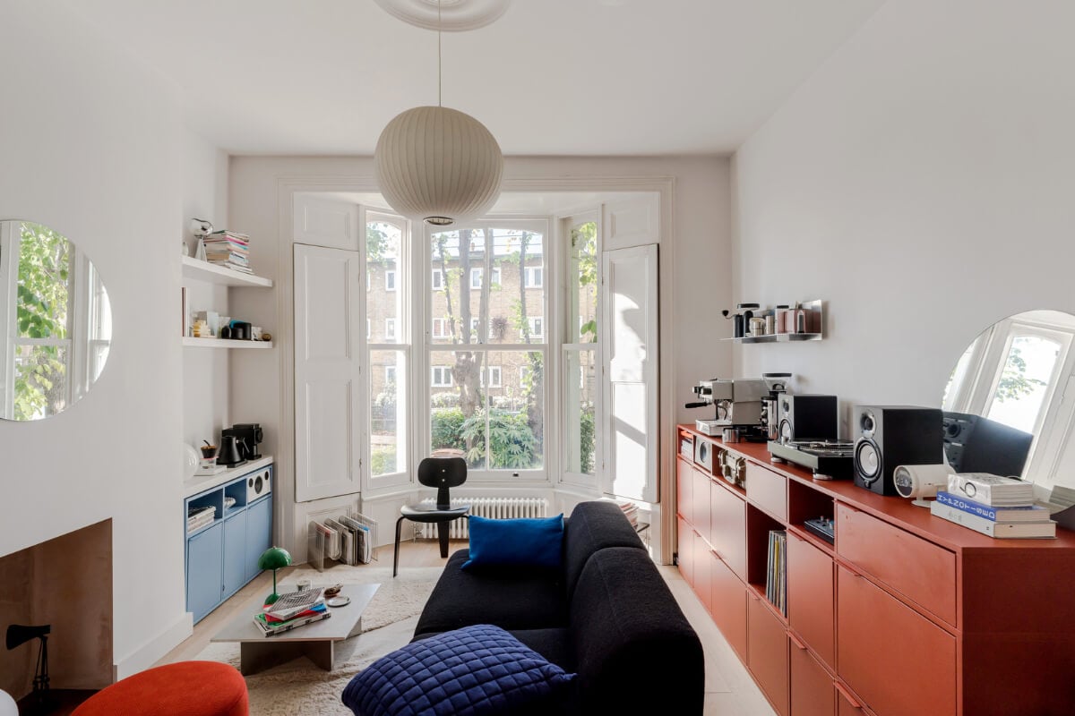 A Modern Apartment in a London Victorian House 1 white living room bay window red and blue cabinets