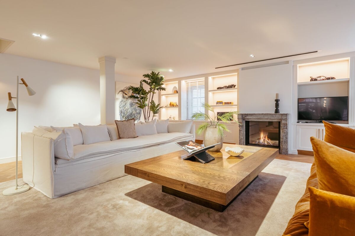 A Unique Ground Floor Duplex Apartment in Amsterdam 11 white living room large rug fireplace