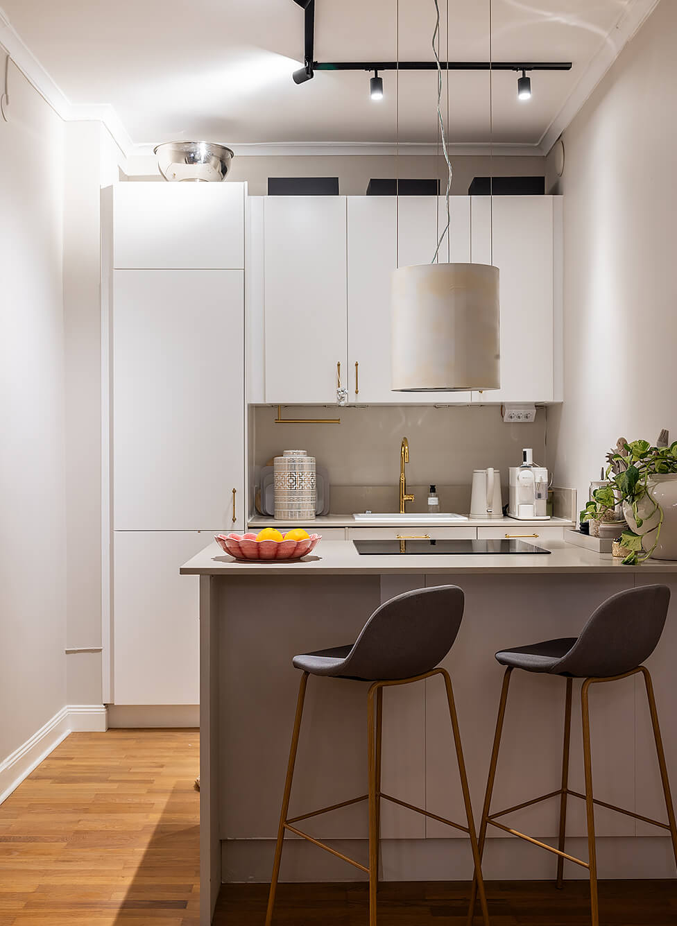 A Tiny and Luxurious Apartment in Stockholm 9 white modern kitchen bar stools
