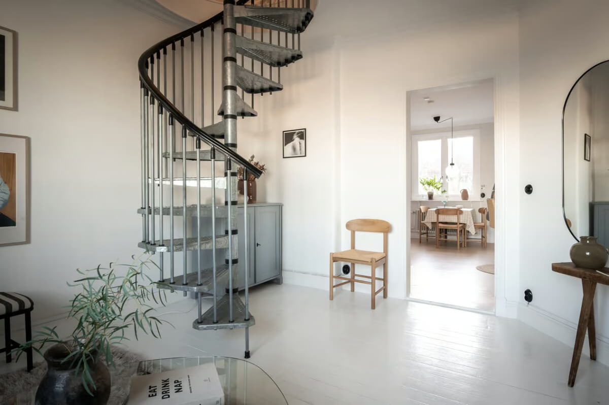 A Duplex Apartment with Period Features and a Charming Attic Bedroom 5 white open plan living space spiral staircase