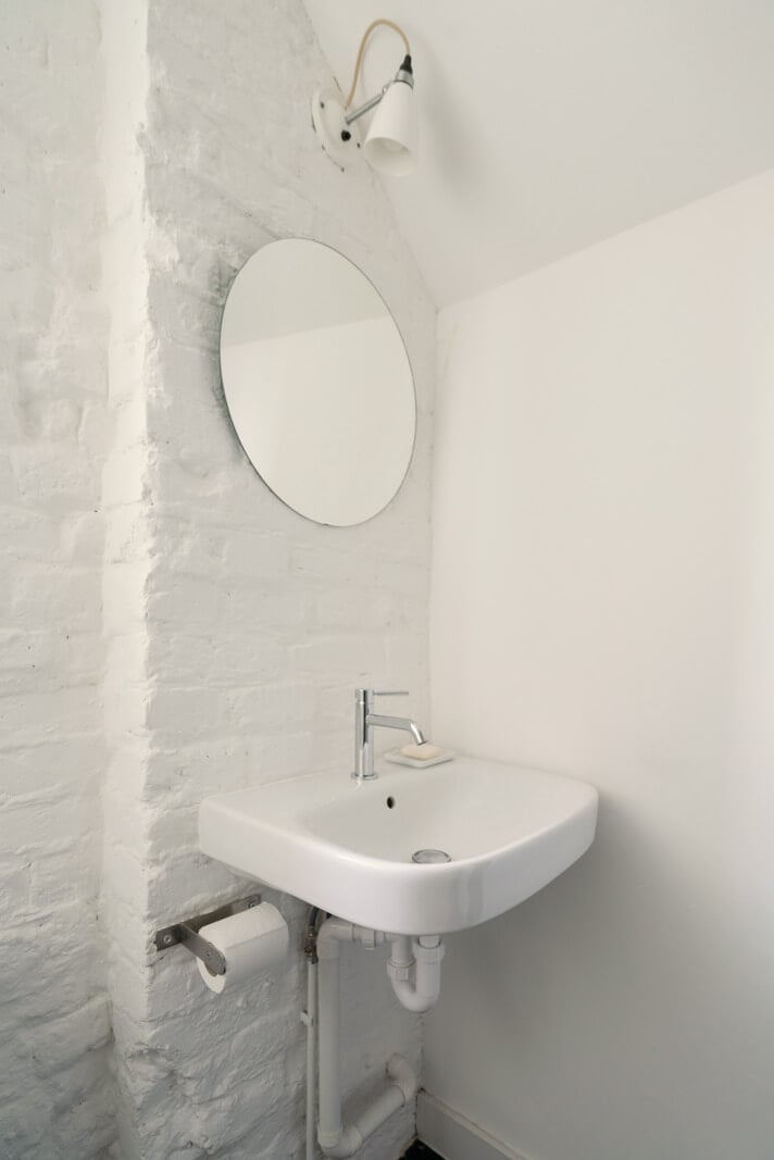 A Light One-Bedroom Apartment in a Victorian Terrace House 18 white painted brick wall bathroom