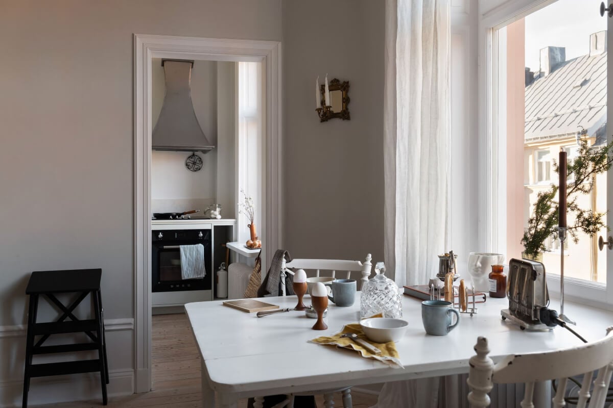 A Small Light Gray Apartment with Period Features 8 white table with view into kitchen