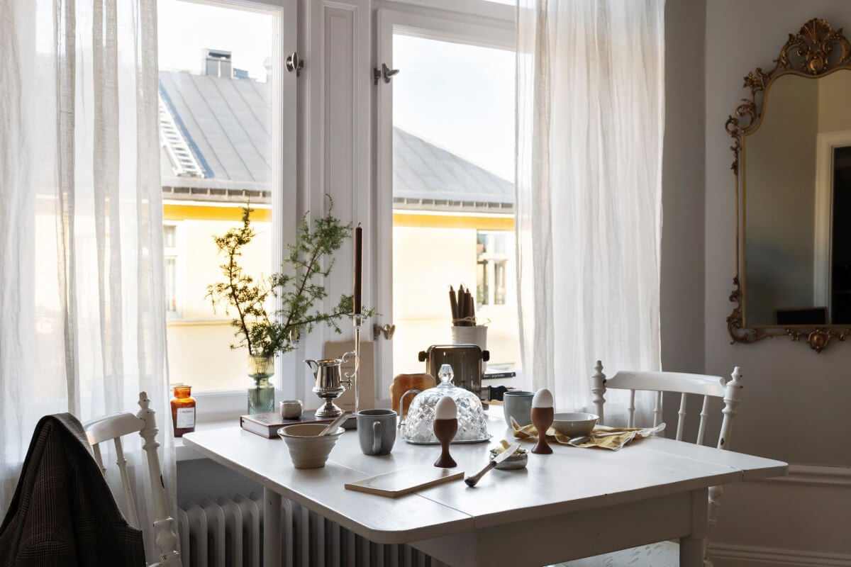 A Small Light Gray Apartment with Period Features 12 white vintage table under window scandi living room