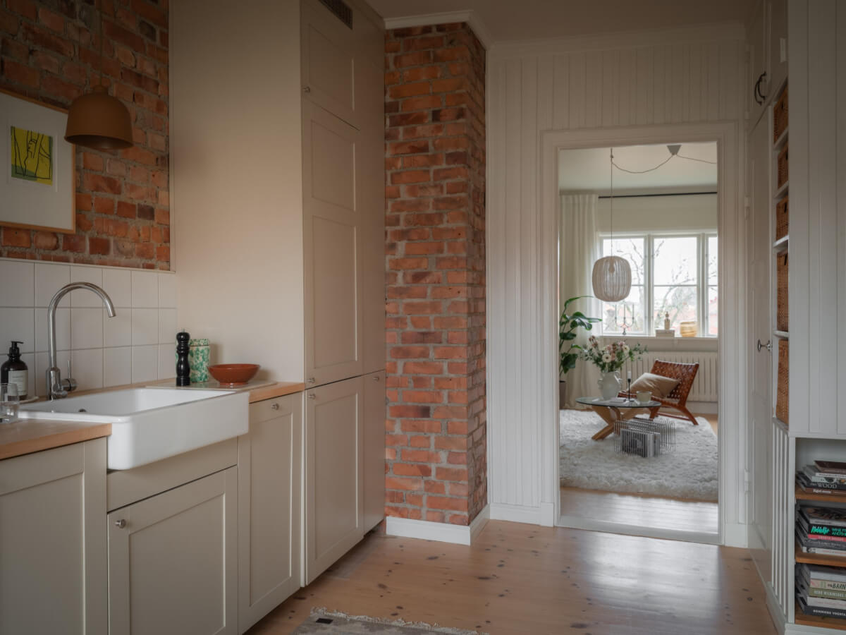 A Renovated Duplex Apartment with Exposed Brick Walls 12 wood paneling exposed brick kitchen